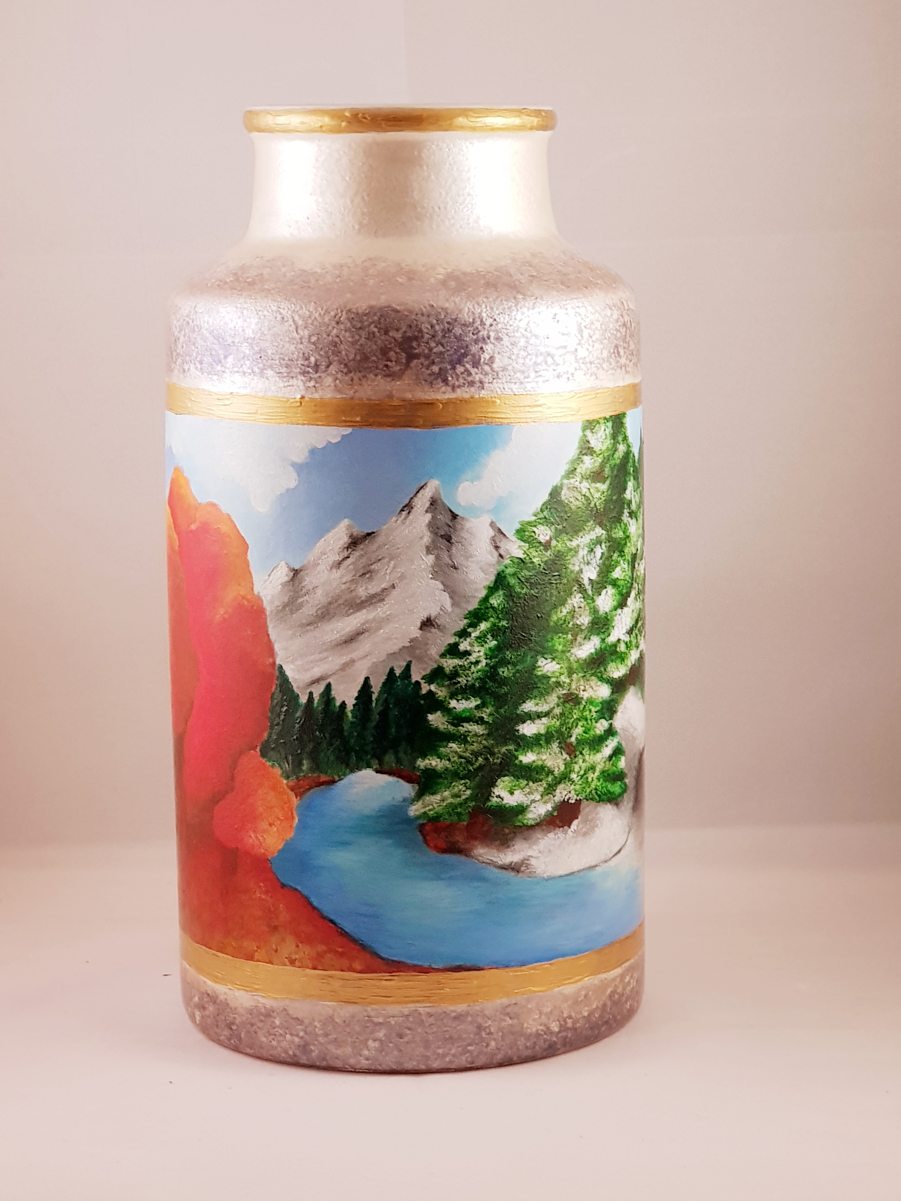 Painted seasons, mountains on ceramic vase.