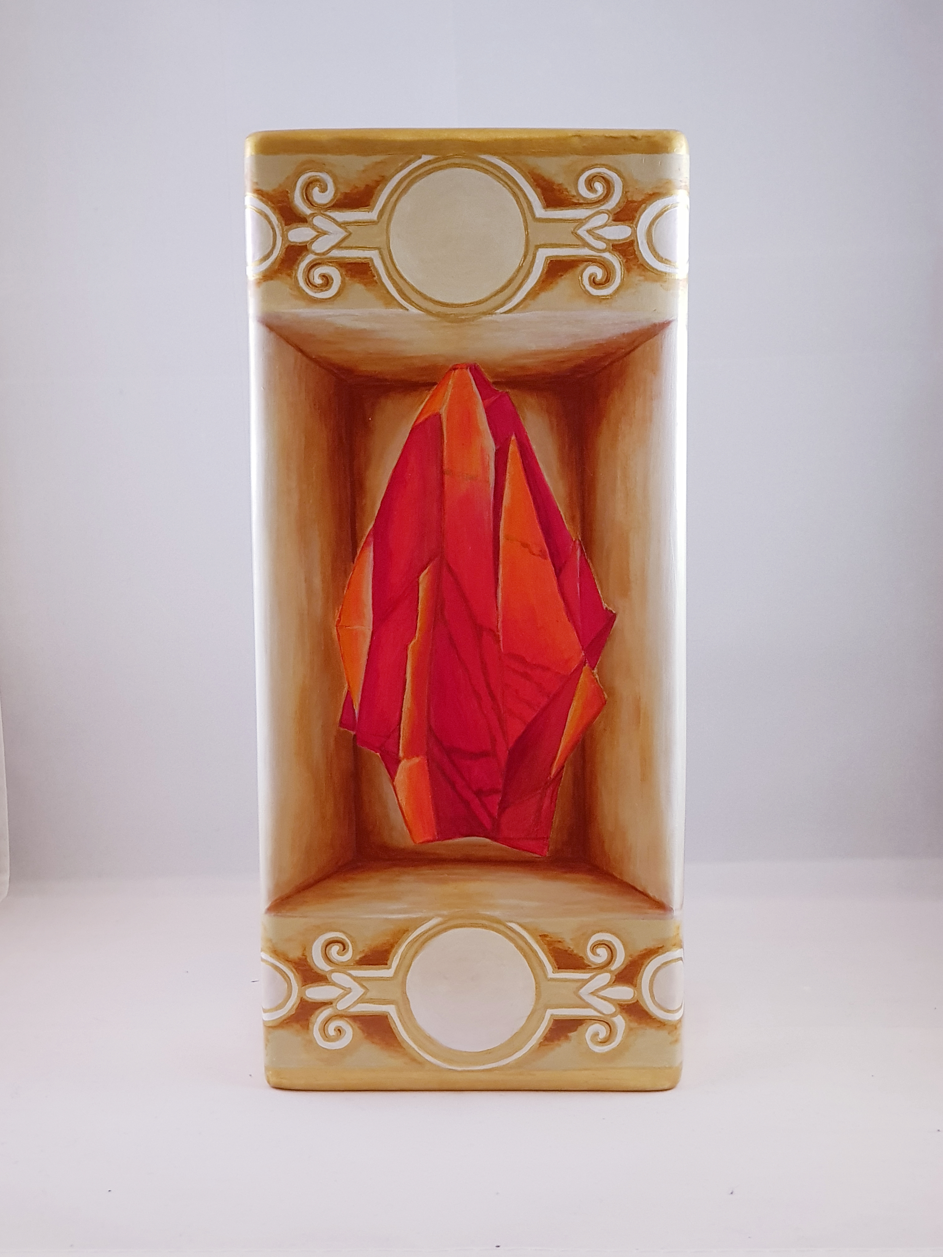 Painted red gem on ceramic vase.