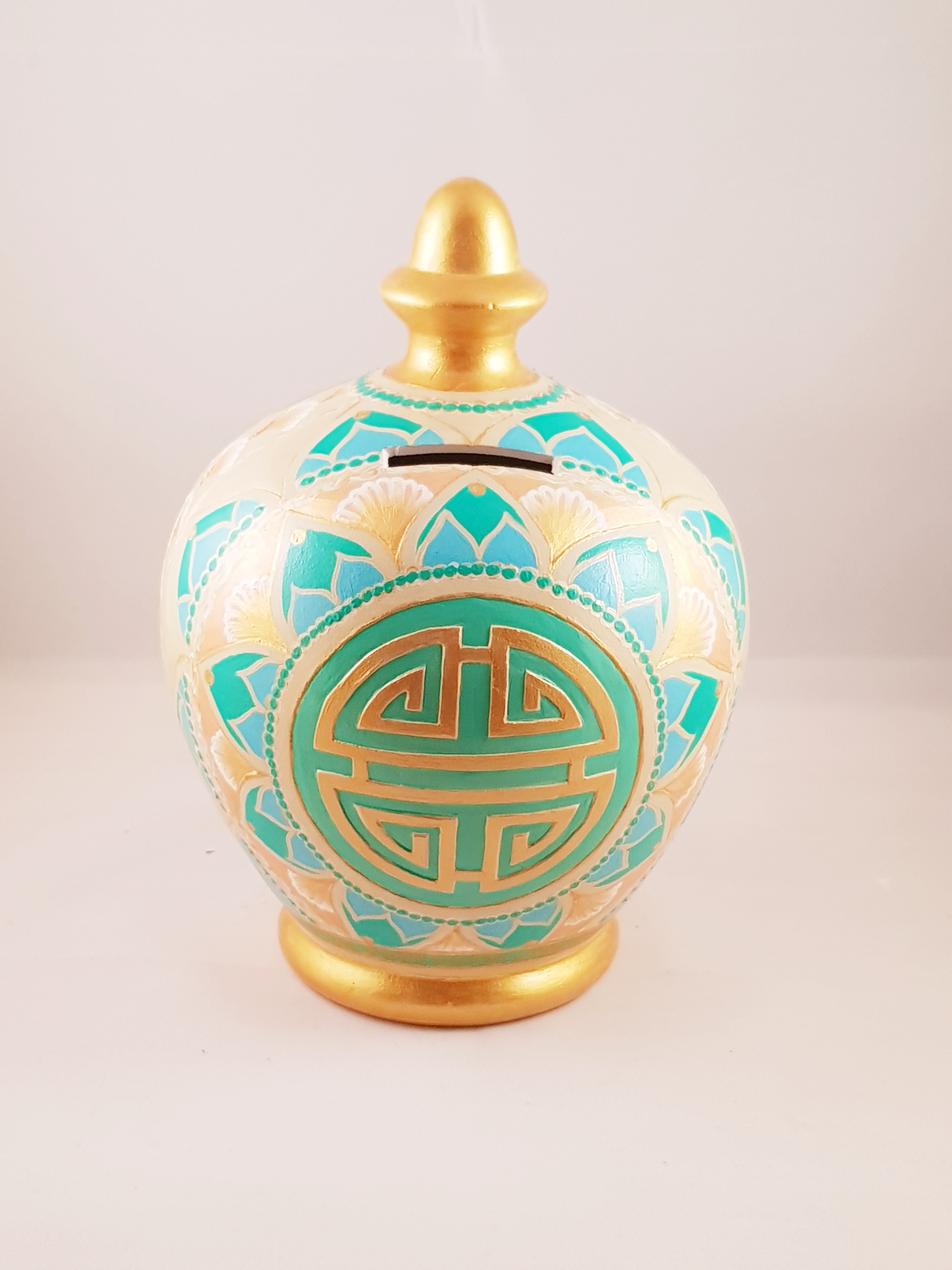 Engraved chinese wealth symbol on ceramic piggy bank.